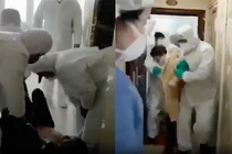 Quyết chống cự, người nghi nhiễm virus corona bị lôi ra khỏi nhà đến khu cách ly