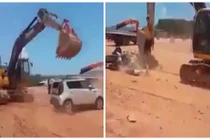 Công nhân lái máy xúc "bổ" nát xe con của ông chủ
