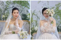 Vợ Huy Khánh hóa cô dâu gợi cảm khi về nước