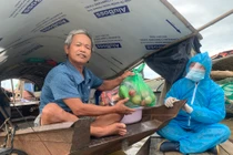 Đi thuyền ra bãi giữa sông Hồng tặng gạo cho người khó khăn