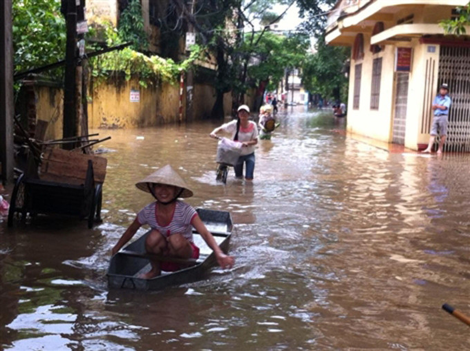 Người Hà Nội đi thuyền trên phố. Ảnh: Tiền Phong