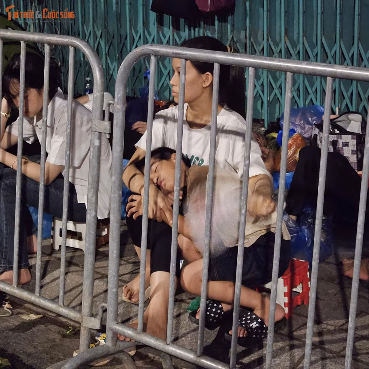 Một trẻ nhỏ nằm ngủ trong lòng người thân.