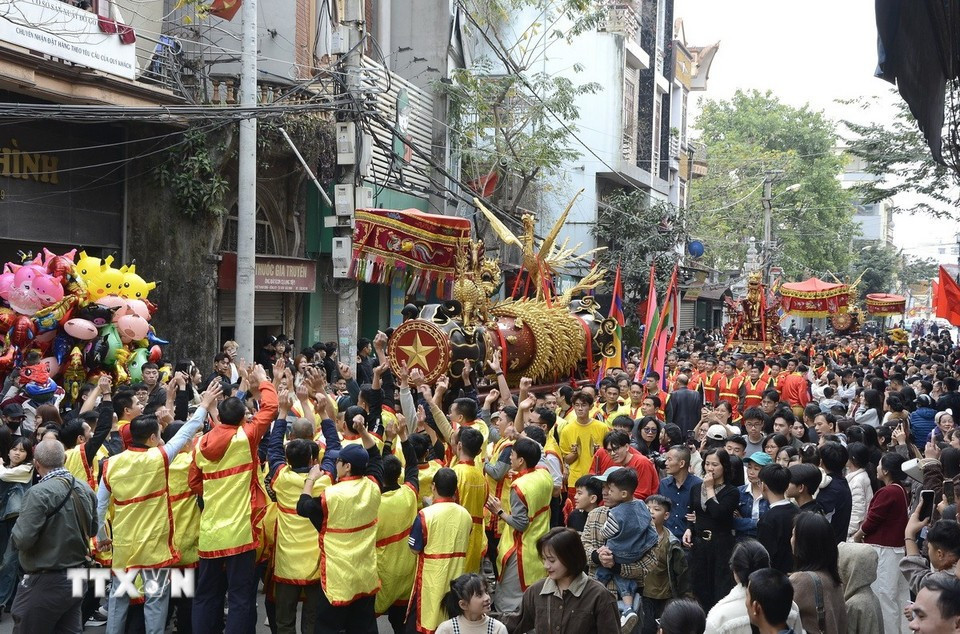 Rước pháo dọc đường làng. (Ảnh: Thái Hùng/TTXVN)