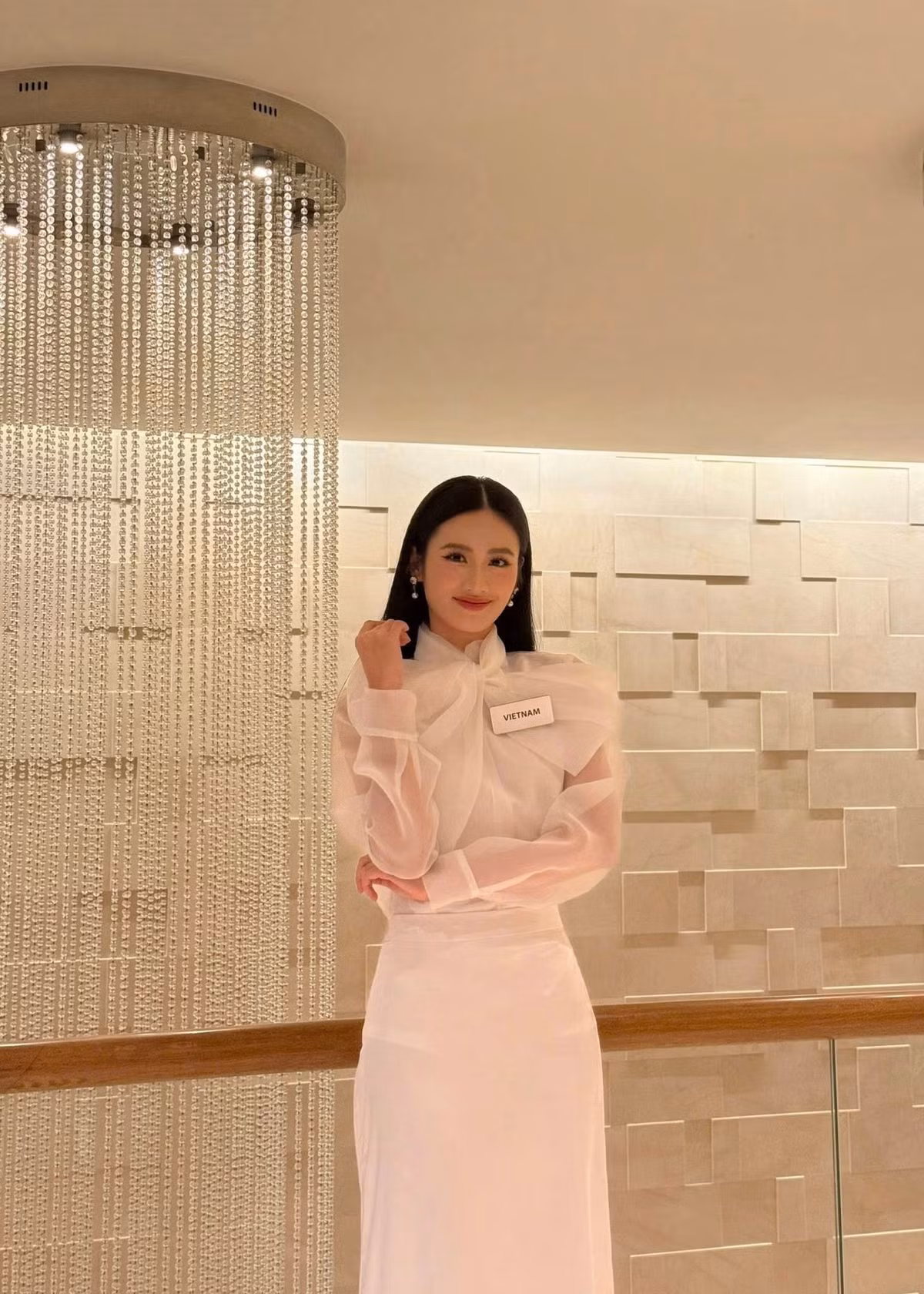 Hoa hậu Ý Nhi vừa hoàn thành vòng đầu tiên của phần thi Thử thách đối đầu. Trong phần thi, cô diện áo trắng kết hợp chân váy suông dài, điểm nhấn là chiếc nơ to bản, tạo sự phá cách cho tổng thể trang phục nữ tính. Ảnh: FB Ý Nhi.