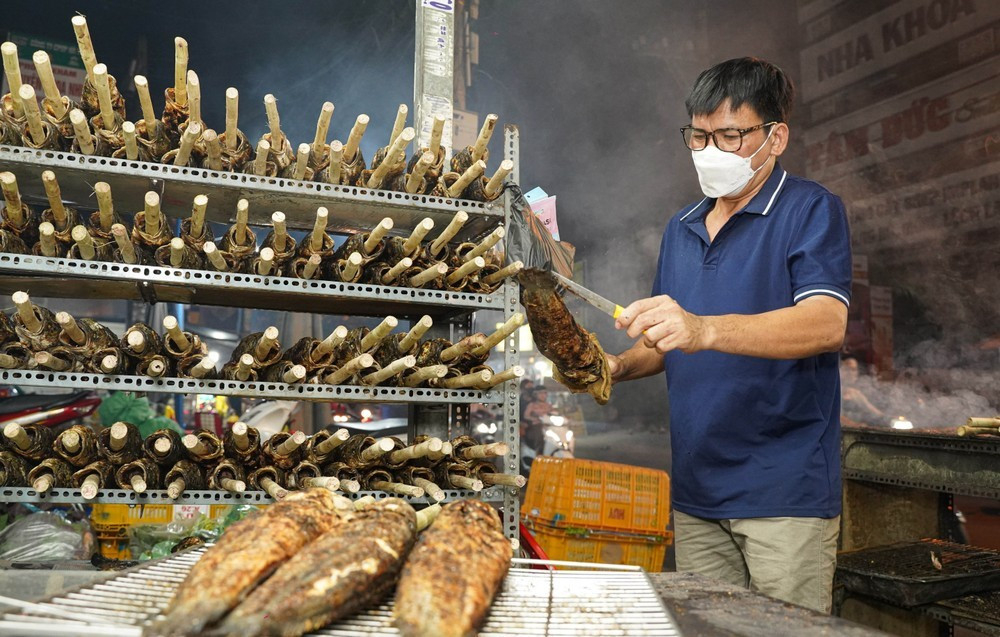 Anh Văn Trung (quê Đồng Tháp) cùng các nhân viên nướng cá tại số nhà 44, đường Tân Kỳ Tân Quý từ 16 giờ. "Năm nào cũng vậy, đến cận ngày vía Thần Tài, tôi đều lên phụ chủ nướng cá lóc, vừa vui, vừa có thêm thu nhập" - anh Trung nói.