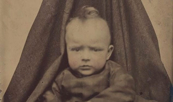 Nhiếp ảnh thuở ban đầu có thời gian phơi sáng dài. Đối tượng được chụp cần phải đứng yên trong 30 giây trước khi có thể chụp ảnh. Mà với trẻ em, rất khó để người lớn có thể giữ chúng ngồi yên và nhìn chằm chằm vào máy ảnh lâu như vậy. Vì vậy đã có trào lưu chụp ảnh người mẹ giấu mặt. Các bà mẹ sẽ bế, giữ con của họ ngồi im nhưng phải phủ lên mình những bộ quần áo để hòa cùng phông nền.