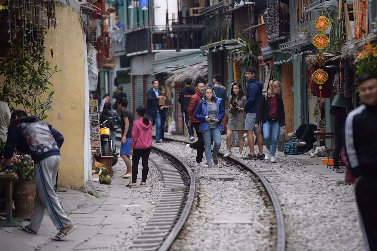 Dọc đoạn đường tàu tại đây vẫn nhộn nhịp cảnh tượng khách du lịch đi lại, chụp ảnh trên đường ray, ngồi uống cà phê bên đường tàu để… đợi tàu chạy qua. (Ảnh: Trọng Tùng)