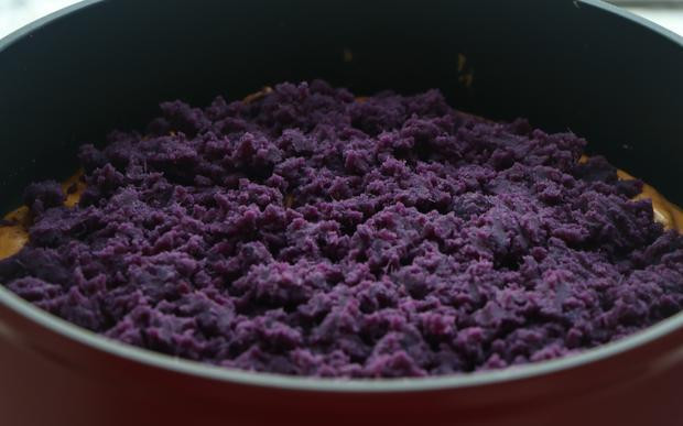 5. Quét một lớp dầu thực vật mỏng lên chảo, đổ một nửa lượng bột trộn bí đỏ vào, dàn mỏng, đậy nắp và chiên lửa nhỏ khoảng 3 phút. 6. Sau đó ta đổ lớp khoai lang, dàn đều.