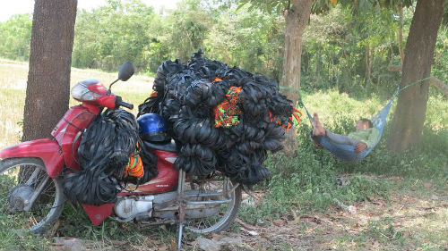 Rong ruổi đường dài, dưới cái nắng có lúc lên tới 42 độ đã khiến anh bán hàng rong mệt lả, phải mắc võng nghỉ ngơi ở rặng cây ven đường.