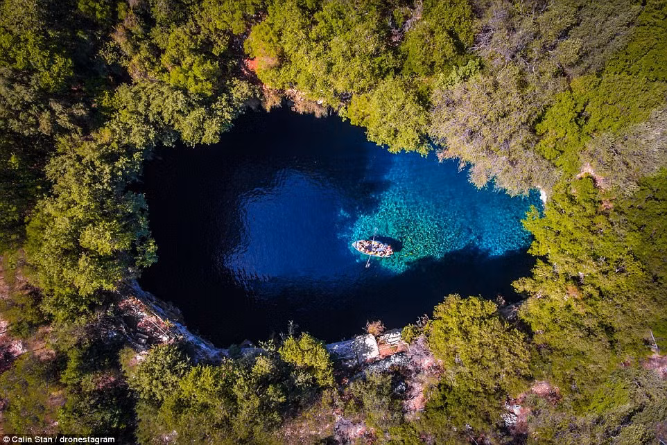 Một chiếc thuyền chở du khách khám phá hang Melissani trên hòn đảo Cephalonia, Hy Lạp.
