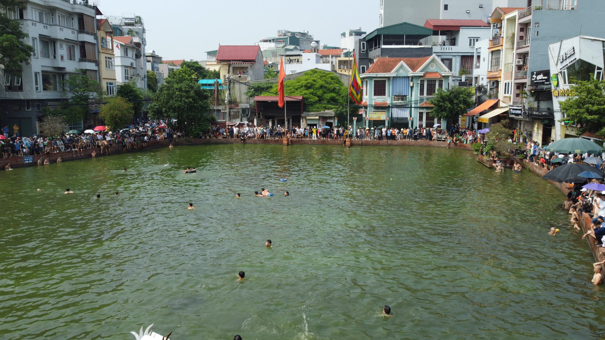 Người dân làng đứng kín mít quanh vòng ao làng Triều Khúc.