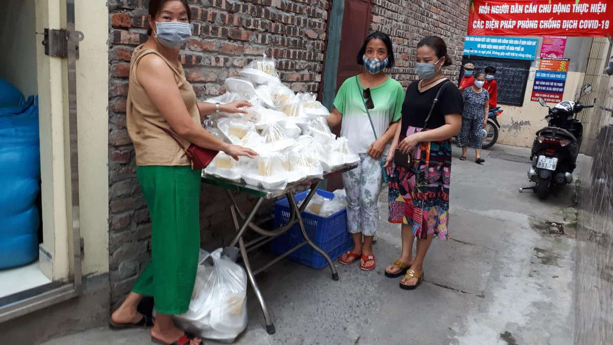 Một buổi phát cơm của nhóm thiện nguyện tại "xóm chạy thân" trên đường Lê Thanh Nghị (Hà Nội).