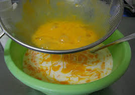 Tiếp đó, dùng rây để lọc hỗn hợp trứng sữa tươi một lượt nữa để hỗn hợp hòa đều và mịn hơn. Lọc trứng sữa xong bạn cho tiếp 2 ống vani vào hỗn hợp và khuấy nhẹ tay