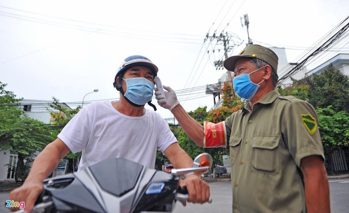 Người dân ra vào các tuyến đường chính dẫn vào chợ đều phải đo thân nhiệt.