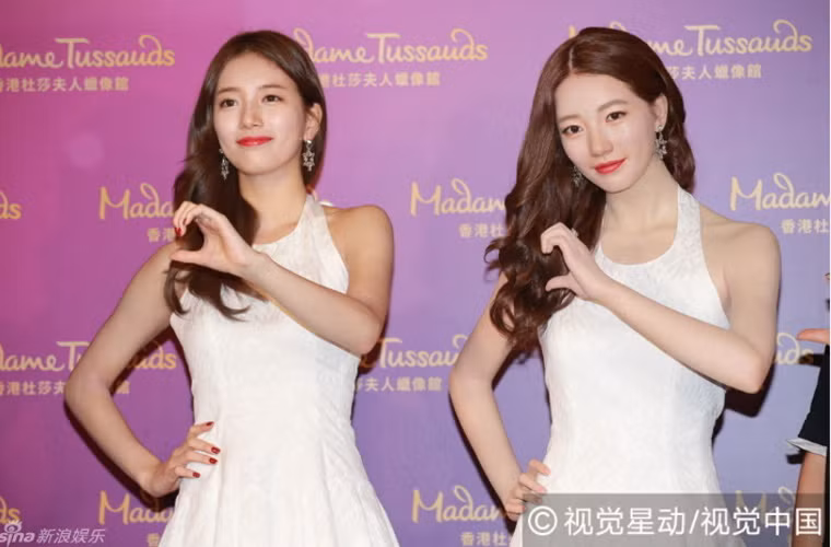 Suzy tạo dáng y hệt tượng sáp để chụp ảnh kỷ niệm.