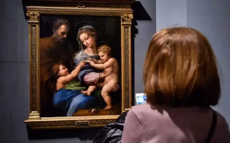 Bức tranh này treo ở Bảo tàng Prado ở Madrid, Tây Ban Nha, đã gây tranh cãi trong giới học thuật, với nhiều lập luận về việc có học trò của Raphael, Giulio Romano, đóng góp vào bức tranh hay không.