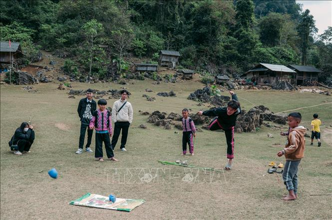 Khách du lịch chơi đánh cù cùng trẻ em tại Hang Táu.