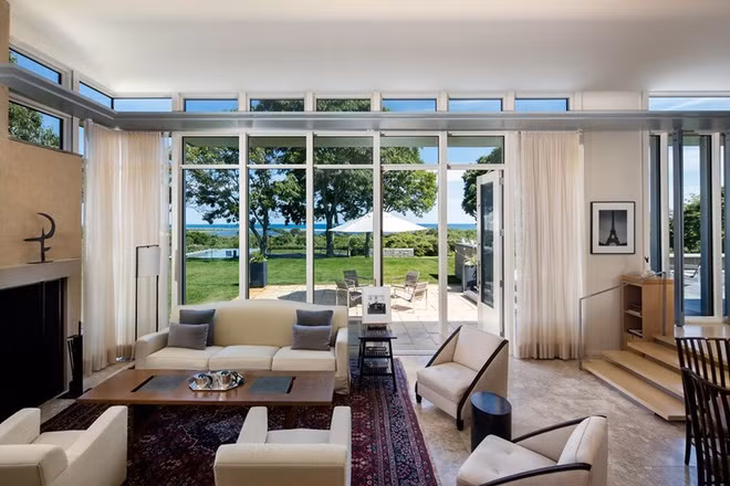 Khu phòng khách thoáng đãng, nhìn ra bãi cỏ xanh và khu bể bơi.