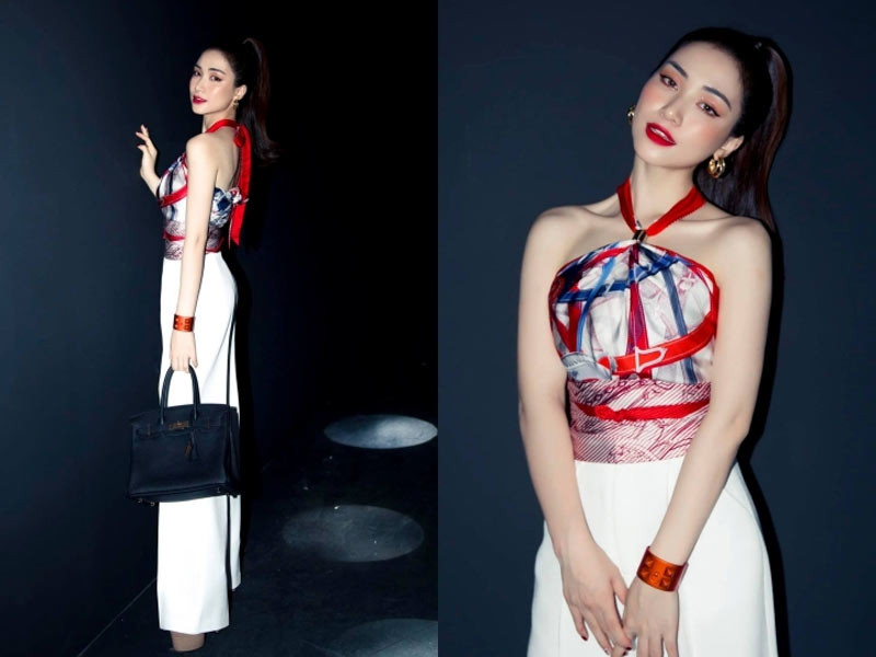 Diện chiếc áo làm từ khăn hiệu Hermes kết hợp với chiếc quần màu trắng ống rộng, Hoà Minzy vừa quyến rũ vừa sang chảnh. (Ảnh: Vietnamnet)