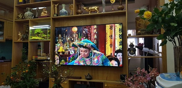 Phòng khách có kệ tủ lớn bày rất nhiều vật kỷ niệm.