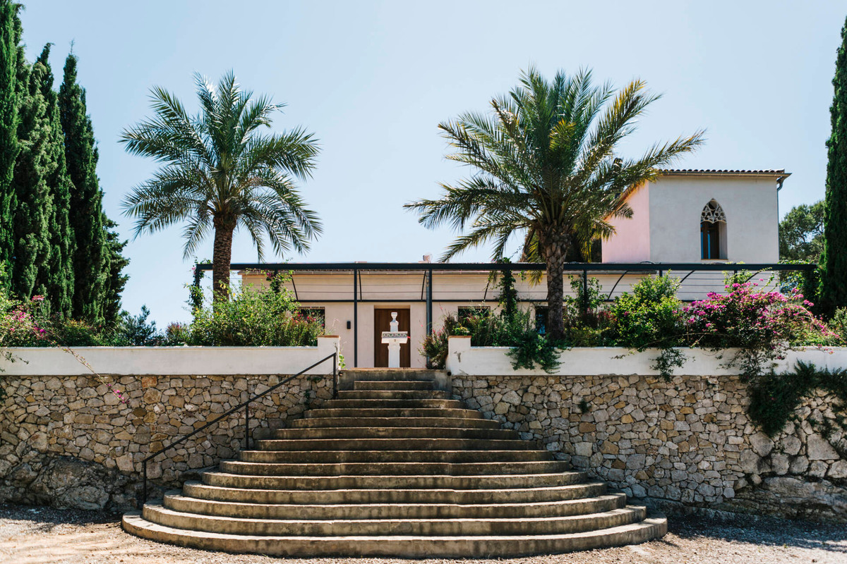 Căn nhà có phần nền cao hơn so với mặt đất nên lối vào nhà sẽ qua một cầu thang lớn và đi qua một khu vườn.