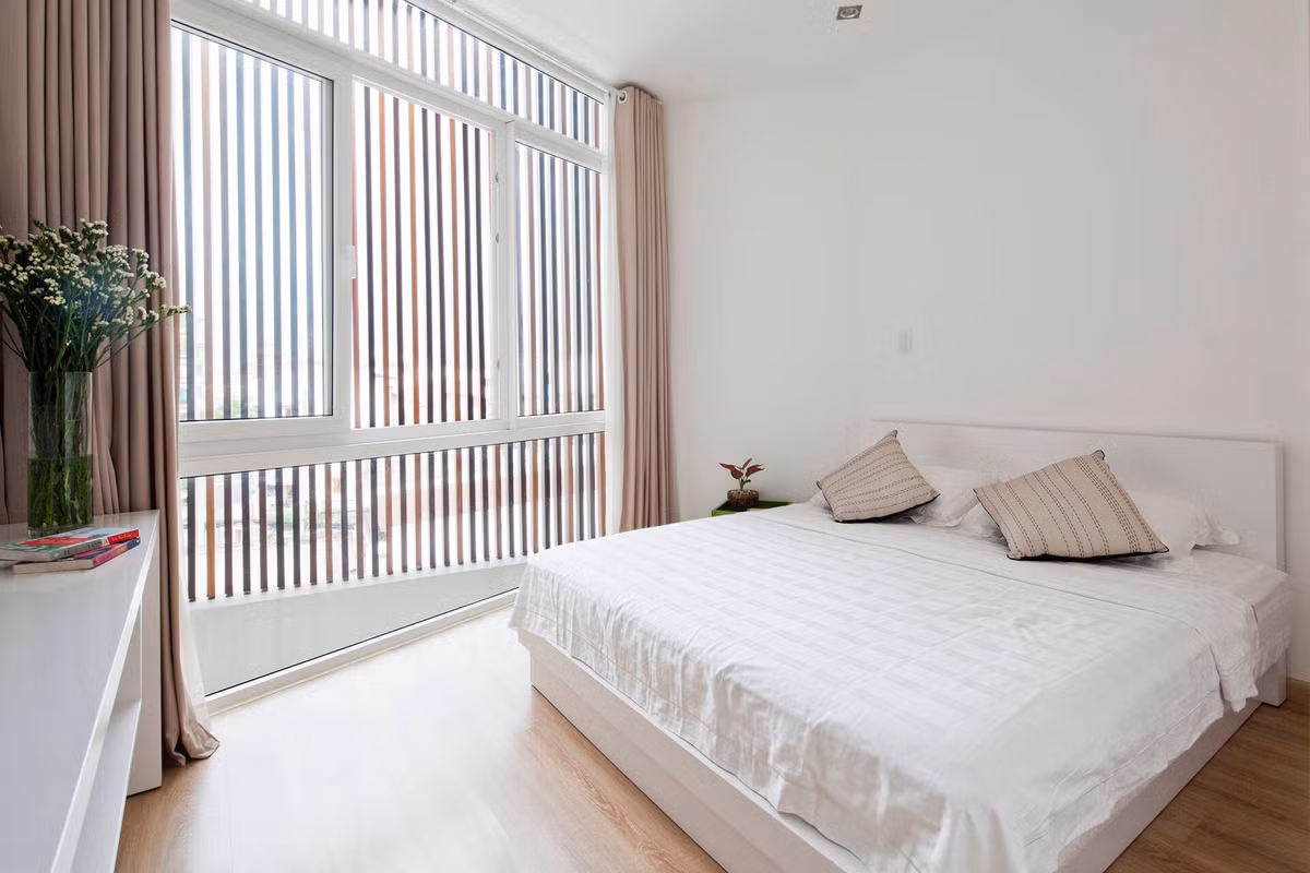 Phòng ngủ với cửa kính lớn lấy ánh sáng tự nhiên.