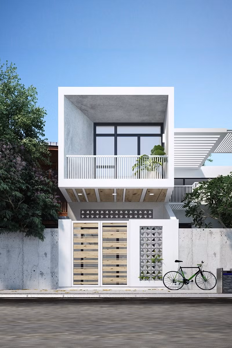 Mặt tiền nhà ống ngập tràn thiên nhiên với cây xanh từ cổng tường rào vào ban công. Ảnh: Holcim.