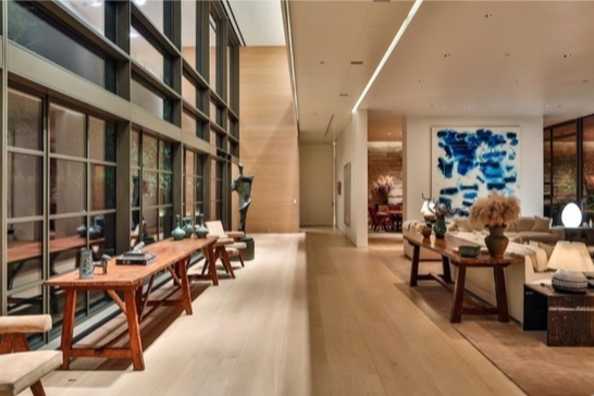 Bên cạnh những ô cửa sổ lớn, phòng khách có kê thêm những chiếc bàn gỗ dài để trưng bày những đồ vật lưu niệm.