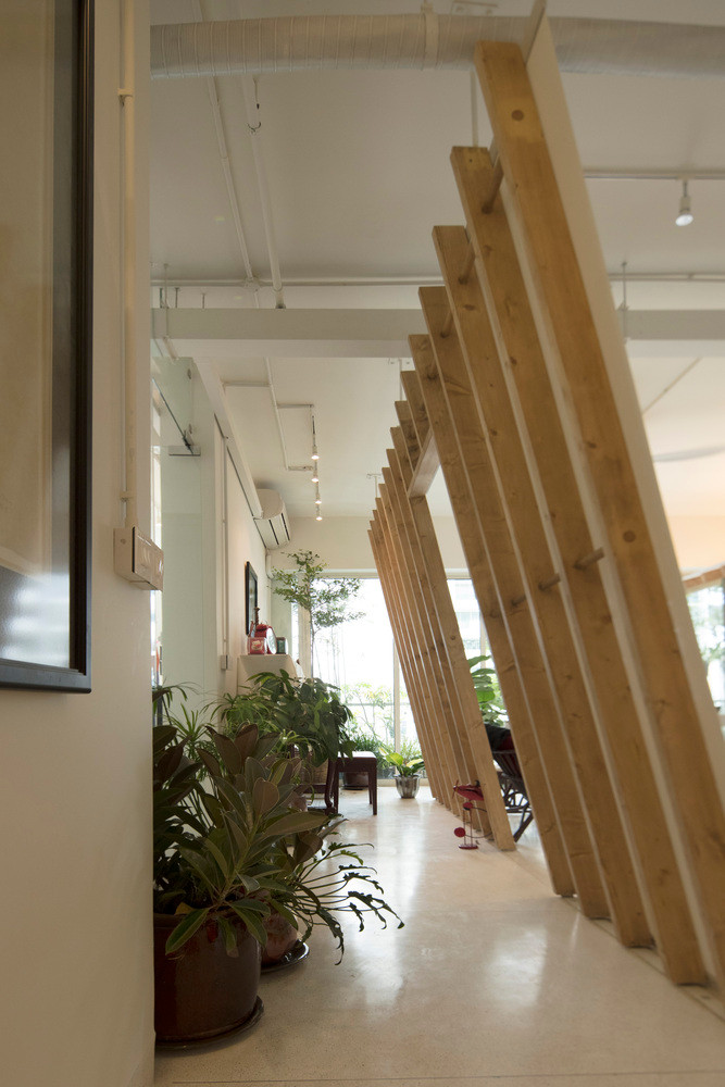 Vách gỗ nghiêng nghiêng tạo lối đi nhỏ như con ngõ cạnh nhà.