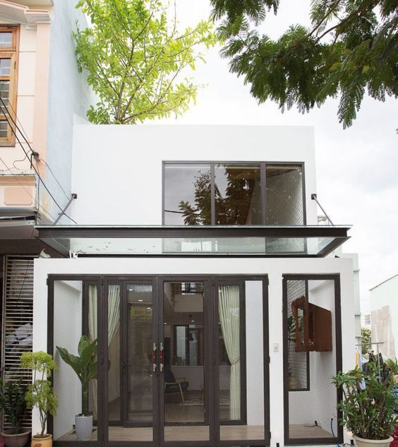 Nhà 2 tầng mái bằng pha trộn phong cách hiện đại đáp ứng nhu cầu sinh sống thoái nhất, kinh phí đầu tư không quá cao.