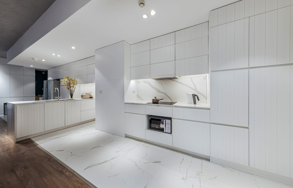 Màu trắng chủ đạo trong khu bếp cũng làm tăng cảm giác rộng rãi.