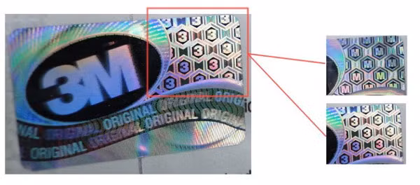 Tem trên khẩu trang 3M thật khi thay đổi góc nhìn bạn sẽ đọc được chữ “3” hoặc chữ “M”. Tuy nhiên tem chống hàng giả chỉ dán trên hộp, nên nếu mua lẻ khẩu trang 3M bạn nên chú ý tới các đặc điểm phân biệt ở trên. Ảnh: Quantrimang.