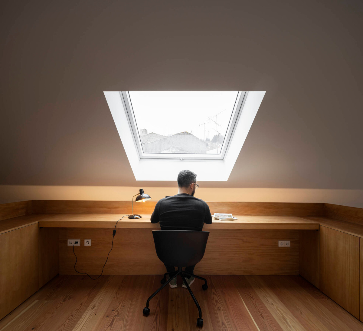 Không gian làm việc yên tĩnh được bố trí ở tầng lửng với giếng trời nằm nghiêng.