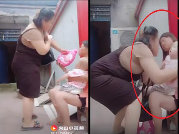 Sau đó, người này nhanh chóng bế đứa bé đi khi mẹ em bé đã ngất (Ảnh cắt từ clip).