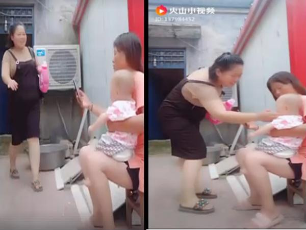 Người phụ nữ rao bán nước giặt tiếp cận em bé (Ảnh cắt từ clip).