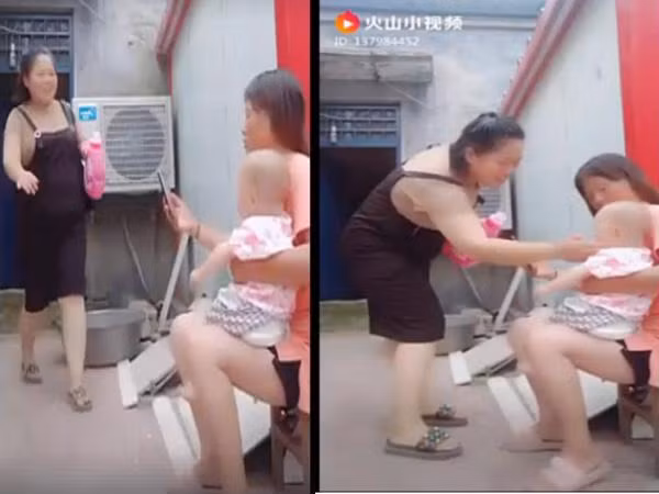 Người phụ nữ rao bán nước giặt tiếp cận em bé (Ảnh cắt từ clip).