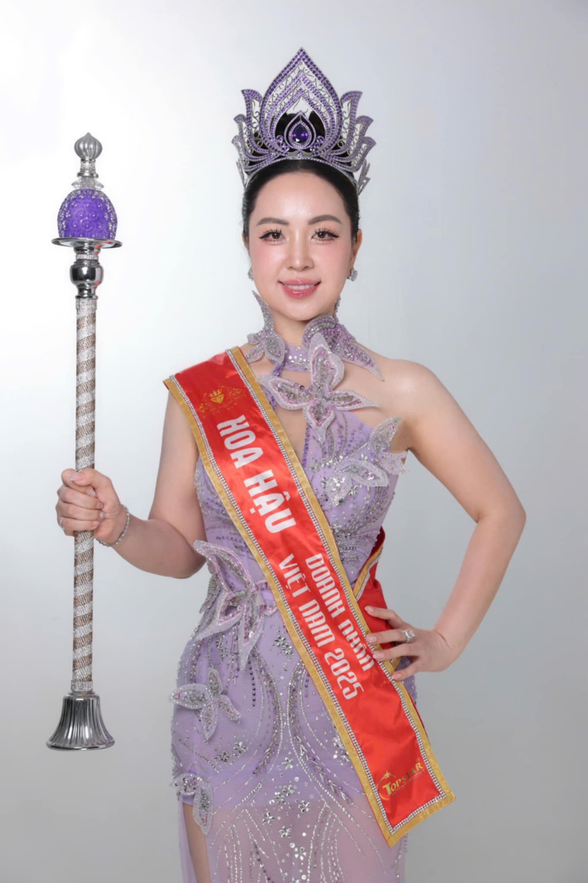 Tân Hoa hậu Hoàng Thu Thuỷ đội chiếc vương miện quyền lực trị giá 1,5 tỷ đồng, tay cầm quyền trượng và đeo dải băng sash danh hiệu danh giá của Hoa hậu Doanh nhân Việt Nam 2025.