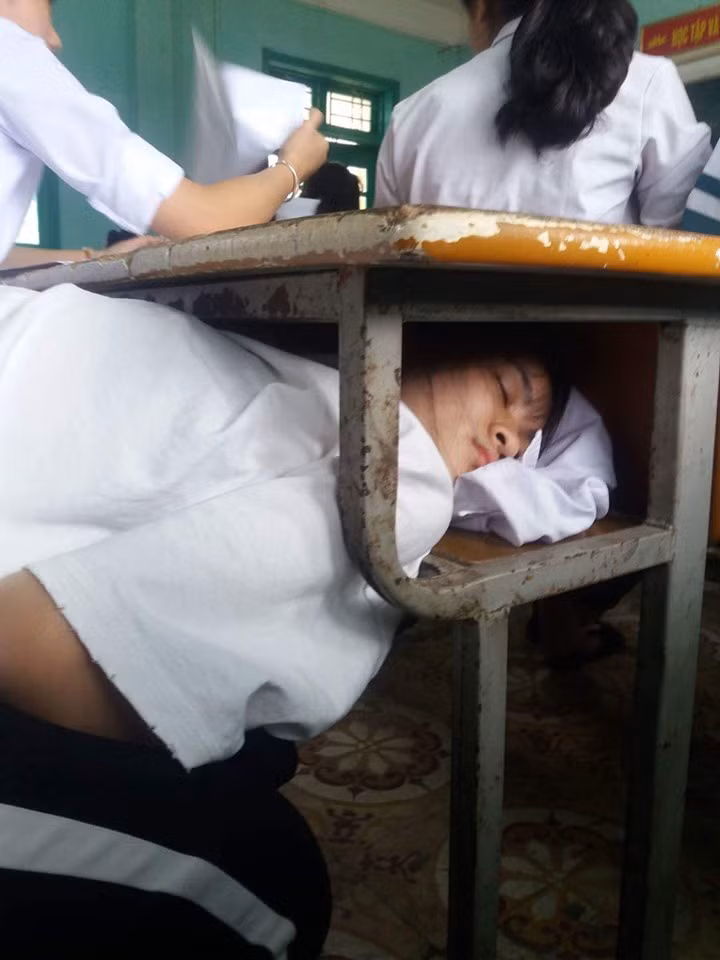 Chui vào gầm bàn cho kín đáo, đố cô giáo phát hiện được. Ảnh: Tổng hợp Facebook