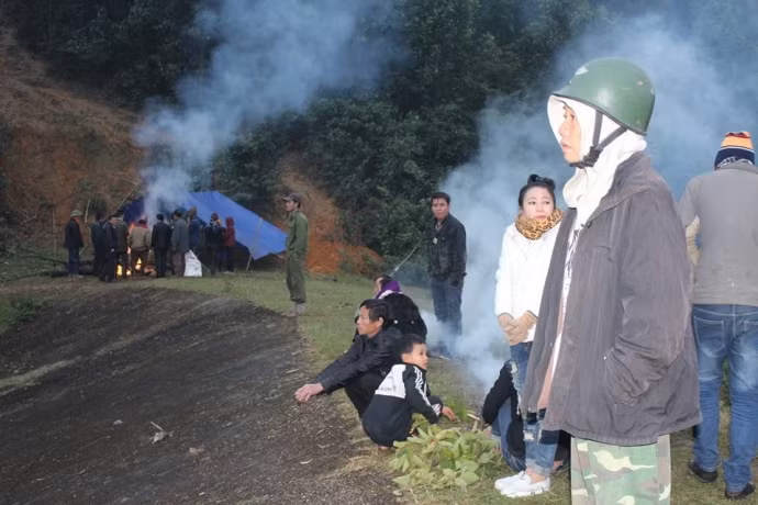 Trời giá rét, mọi người đốt lửa chờ đợi thông tin tìm kiếm thi thể bà Tâm.