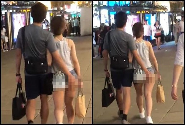 Chính người bạn trai đi cùng cũng không hài lòng với chiếc quần quá ngắn của cô nàng. Anh chàng liên tục lấy tay che chắn bớt cho bạn gái.