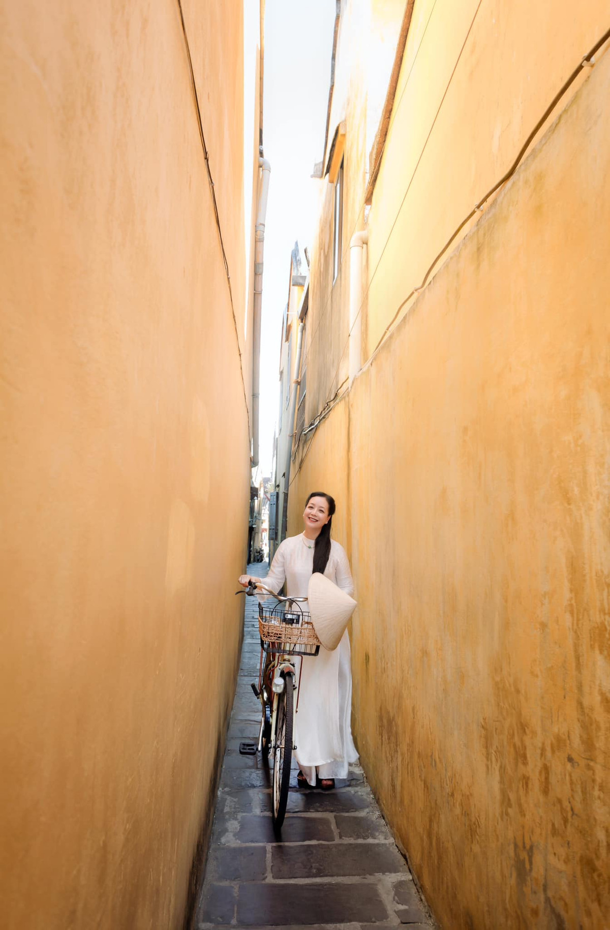 NSƯT Chiều Xuân mặc áo dài nhẹ nhàng trên phố cổ Hội An. Ảnh: FB Nguyễn Thị Chiều Xuân