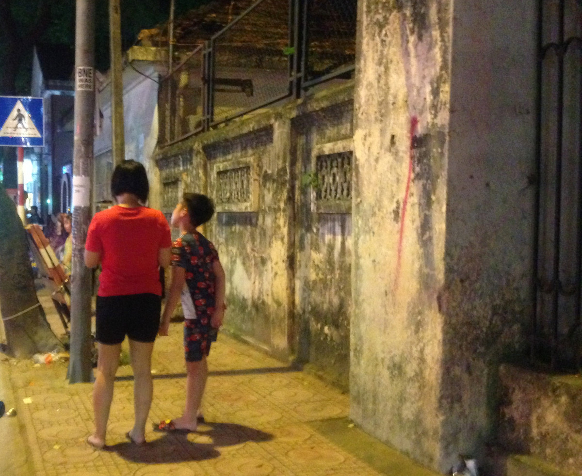 Mặc dù có biển cảnh báo nhưng nhiều người dân vẫn thản nhiên đứng cạnh bức tường mà không hề hay biết tường sắp sập bất cứ lúc nào.