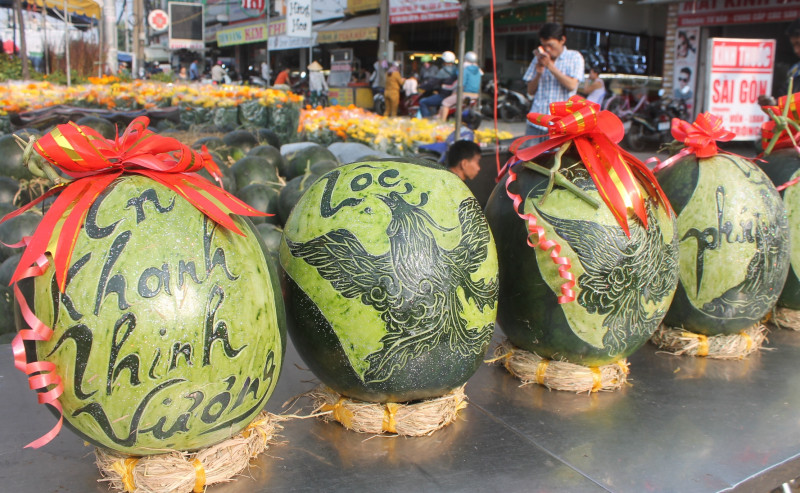 Cũng như bưởi, dưa hấu khắc tỉa các hình dáng độc lạ như hình ông tài lộc, chữ thư pháp: Phúc, Lộc, Thọ...thu hút nhiều khách hàng trong dịp Tết. Ảnh: Báo giao thông.