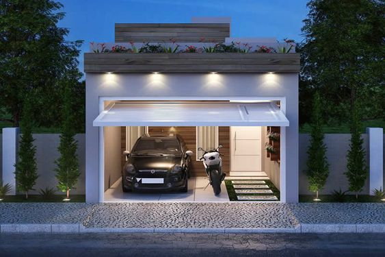 Thiết kế nhà ống độc đáo với phía trên tận dụng để trồng hoa, ốp gỗ làm lan can chắn. Phần cửa cấu tạo cũng khá lạ, tạo 1 khoảng trống để xe. Ảnh: Ngoinhahoanhao