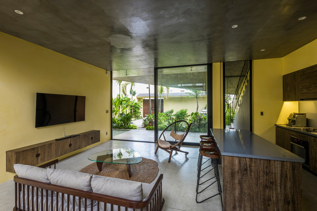 Các chi tiết như vườn nhiệt đới, mái ngói, tường vàng gợi nhớ về kiến trúc nhà ở tại phố cổ Hội An.