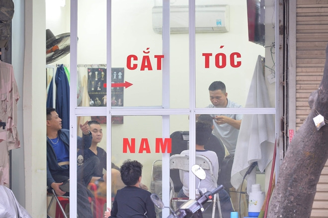 Đông khách không kém tiệm rửa xe là cửa hàng cắt tóc. Cuối năm, từ trẻ em đến người già, ai cũng muốn có mái tóc gọn, đẹp để ăn Tết. Ảnh: Cand