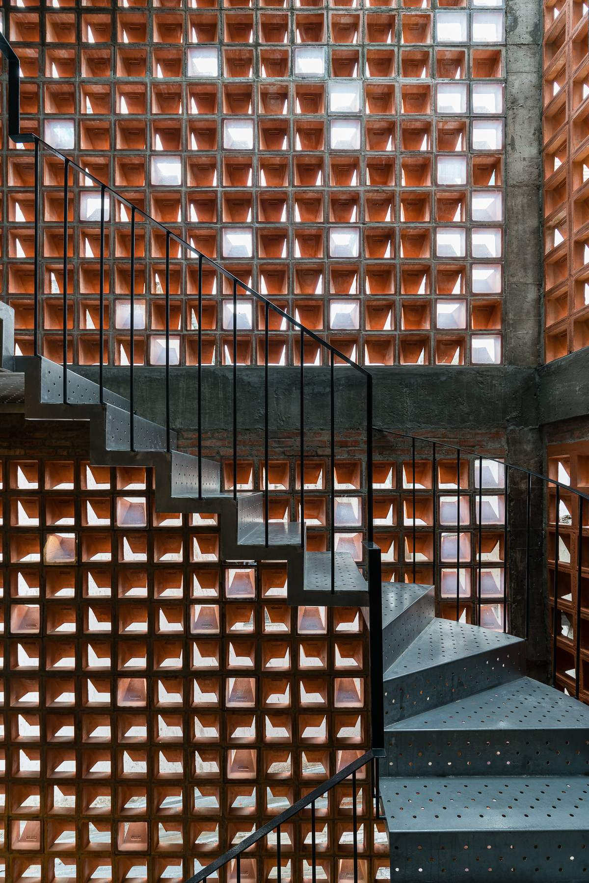 Điểm đặc biệt là HT House được tạo một vỏ bọc bằng gạch bánh ú - vật liệu hiện diện nhiều ở những ngôi nhà cũ xung quanh.