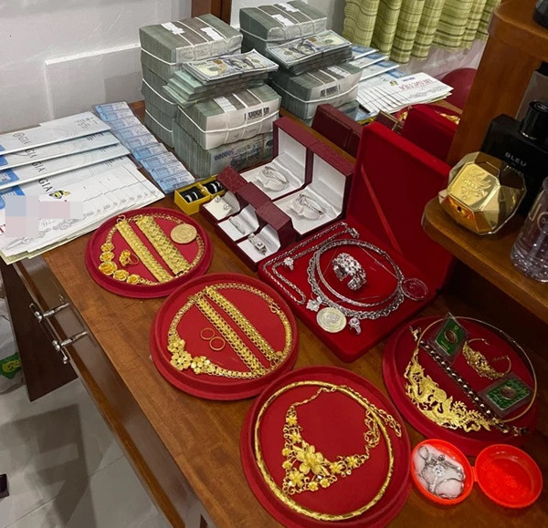 Ngoài tiền mặt thì trên bàn còn la liệt vàng, trang sức, kim cương... không đếm xuể. Ảnh: Pháp luật &amp; bạn đọc