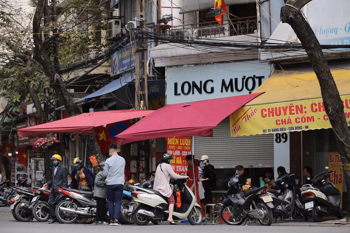 Từ trưa mùng 2 Tết, trên nhiều tuyến phố ở Hà Nội, nhiều hàng quán phục vụ ăn uống mở trở lại.