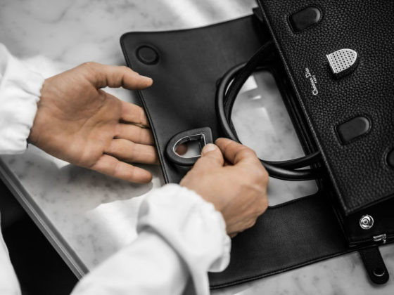 Chiếc túi có thiết kế nắp mở ra phía sau, có khóa đóng và móc khóa bên hông với dây đeo.